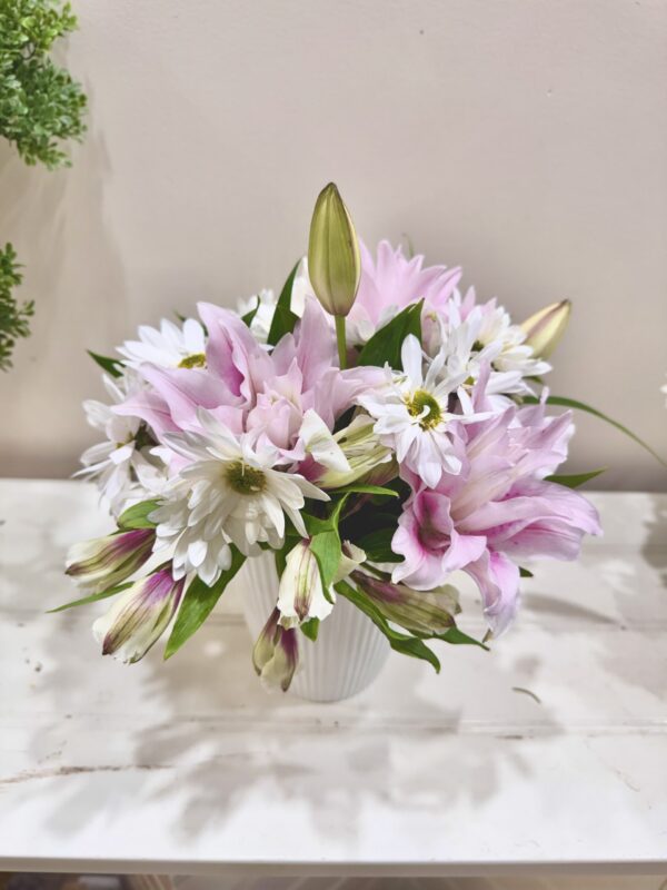 "Monthly Special 2" a bouquet of white daisies and pink florals with budding lilies in a white vase